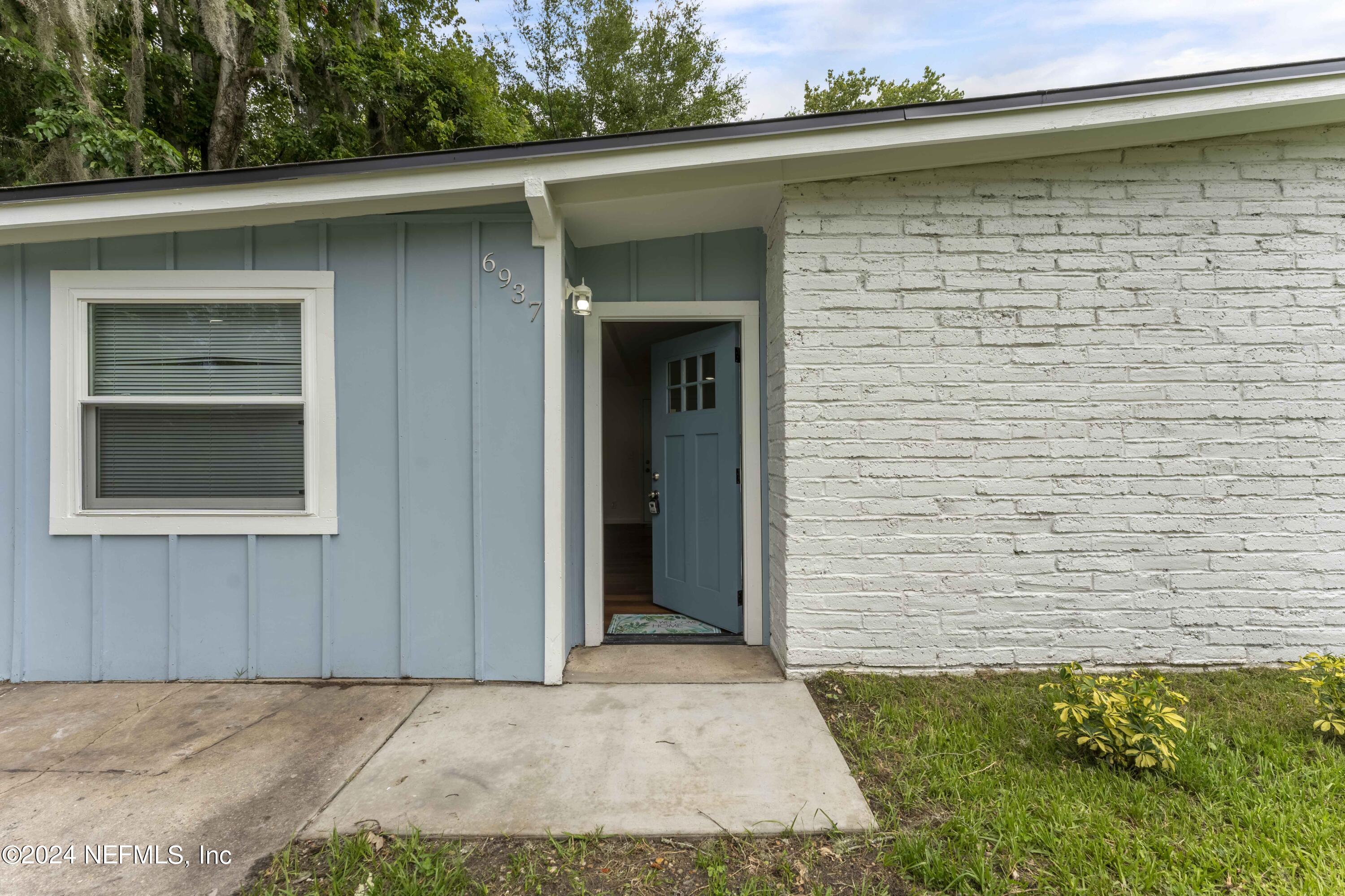 6937 Rollo Road Jacksonville, FL 32205 - Photo 3 of 26 a view of front door of house
