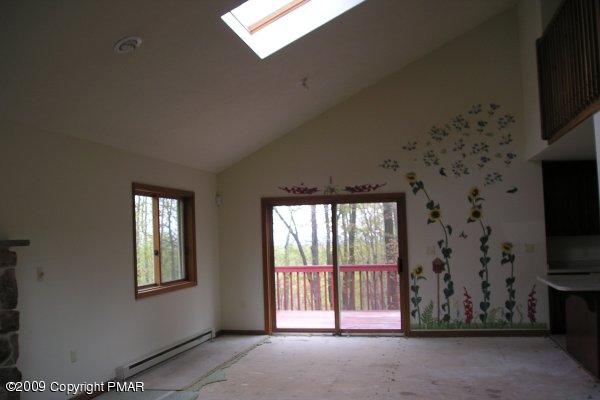 21 Old Timber Road Mount Pocono, PA 18344 - Photo 5 of 8 a view of an empty room with a fireplace and a flat screen tv