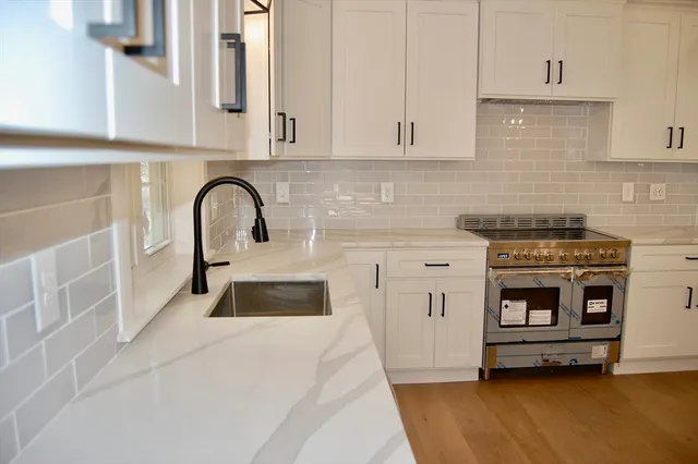 a kitchen with a sink and a stove top oven