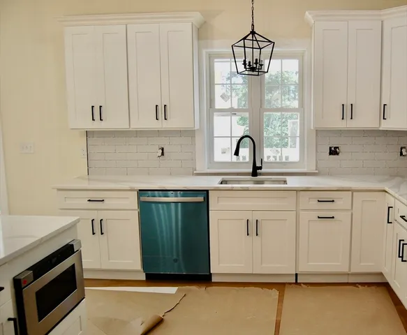 a view of a kitchen with stainless steel appliances granite countertop cabinets and a wooden floor
