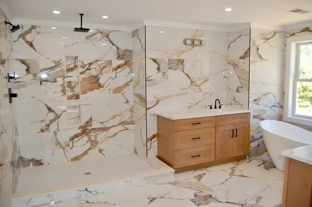 a bathroom with a double vanity sink a mirror and a bathtub