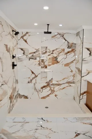 a bathroom with a tub sink and mirror