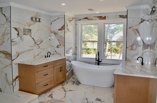 a bath tub sitting in a bathroom next to a window