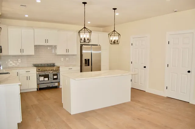 a view of kitchen and white cabinets