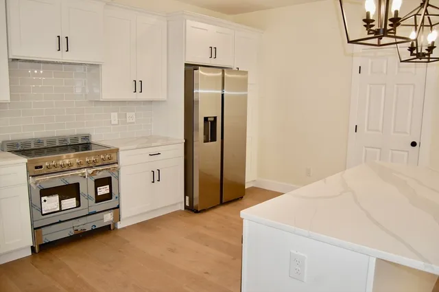 a kitchen with a stove and a refrigerator