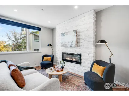 a living room with furniture fireplace and window