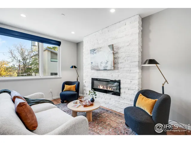 a living room with furniture fireplace and window