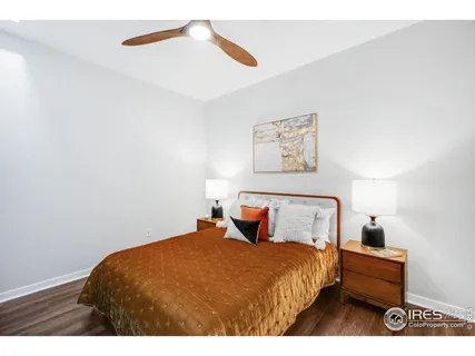 a bedroom with a bed and a night stand