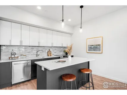 a kitchen with a sink cabinets and wooden floor