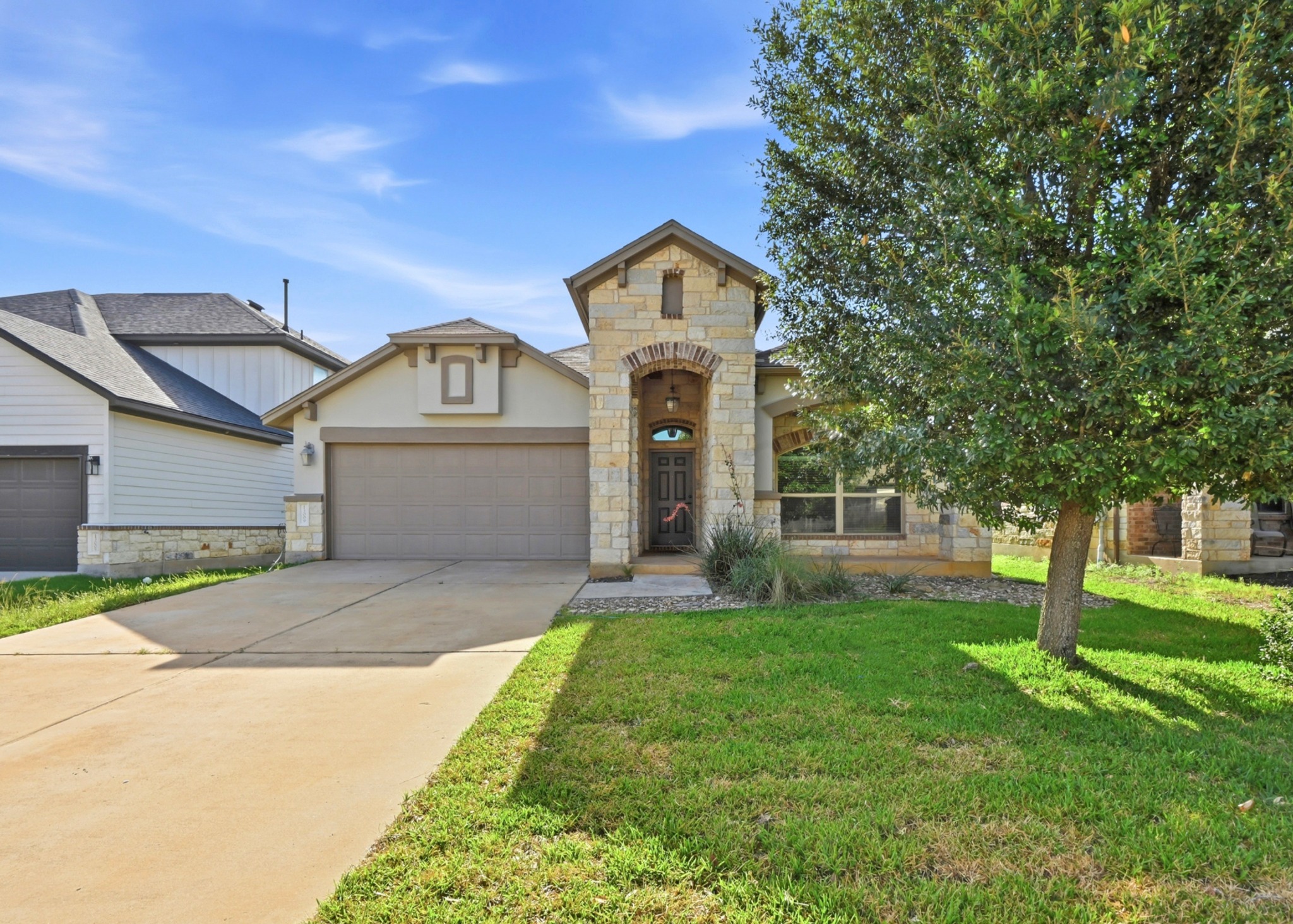 13009 Olivers Way Manchaca, TX 78652 - Photo 3 of 37 a front view of a house with a yard and trees