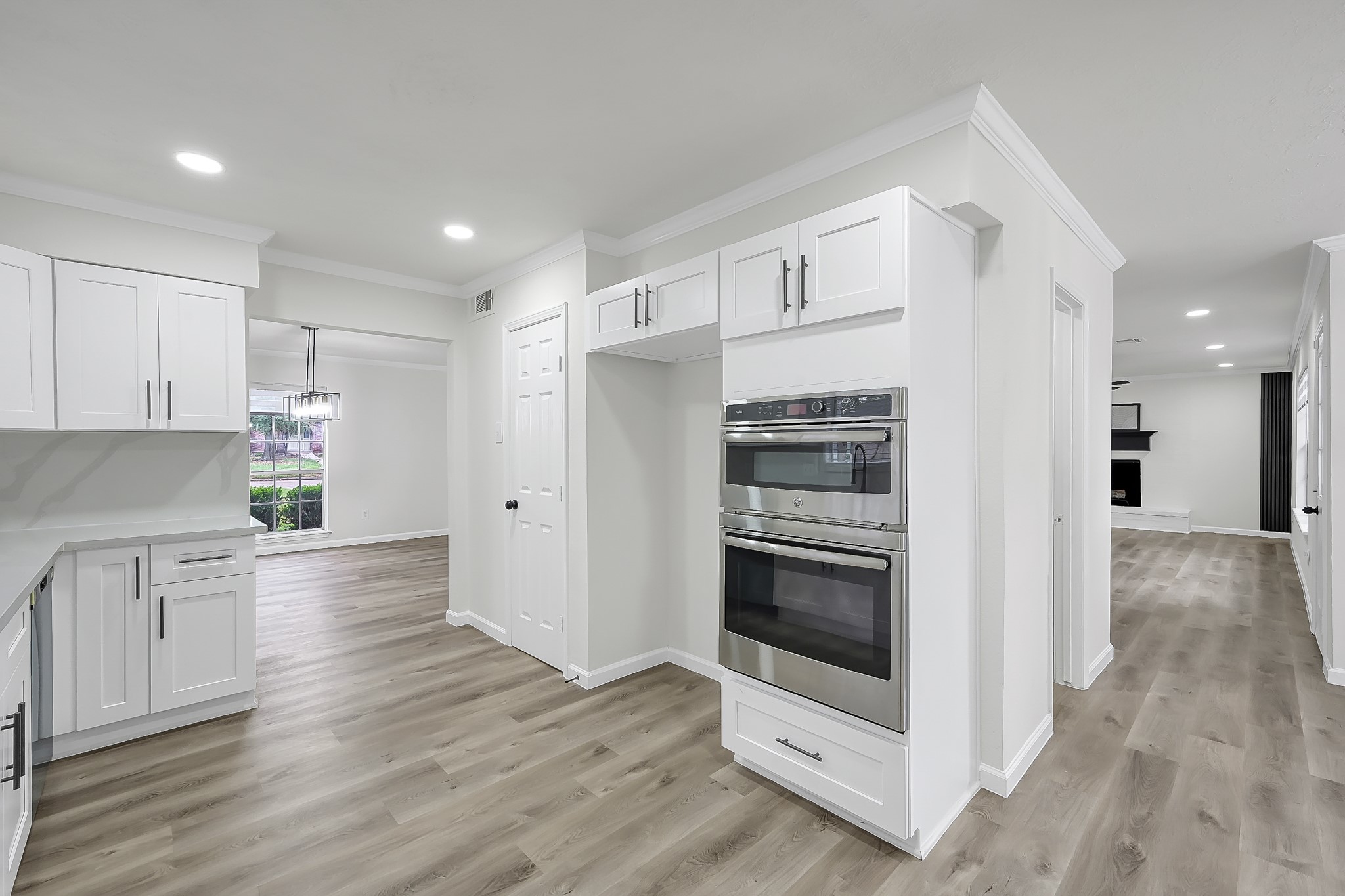 7610 Theisswood Road Spring, TX 77379 - Photo 12 of 42 a kitchen with stainless steel appliances a stove a microwave and white cabinets