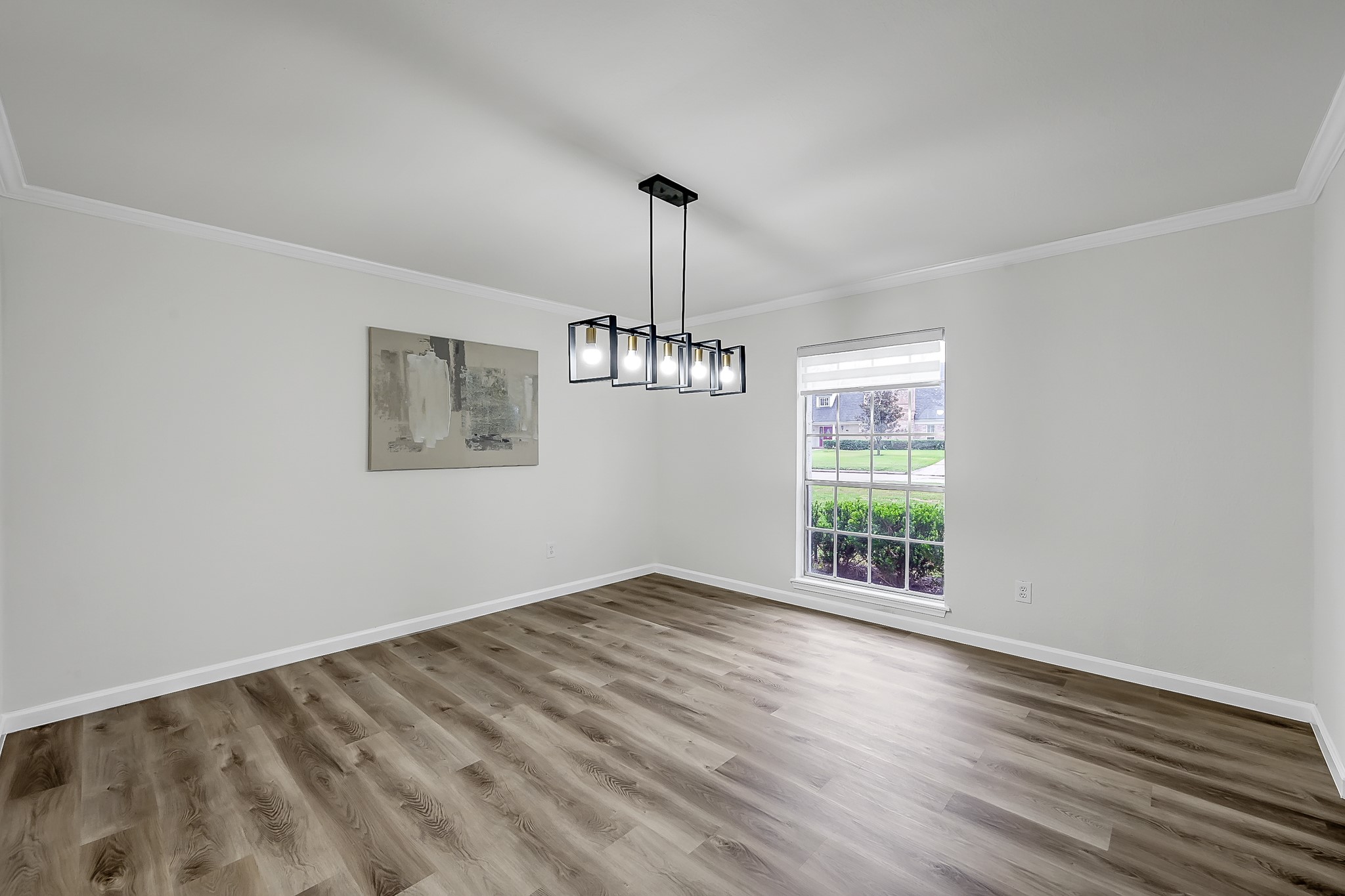 7610 Theisswood Road Spring, TX 77379 - Photo 14 of 42 a view of an empty room with wooden floor and a window