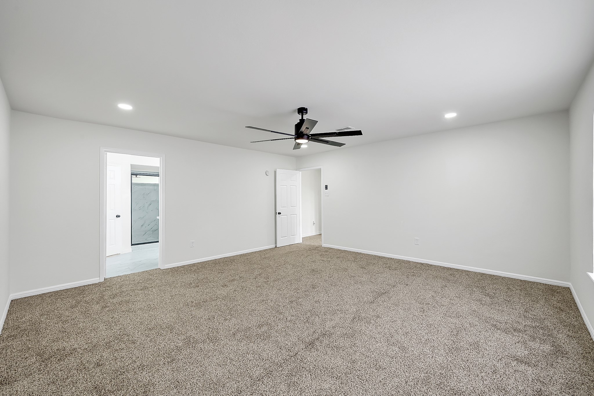 7610 Theisswood Road Spring, TX 77379 - Photo 21 of 42 a view of a big room with windows and ceiling fan