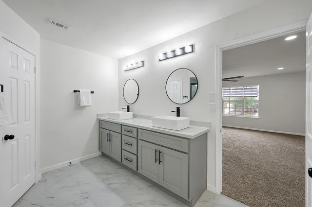 an empty room with a window and a ceiling fan