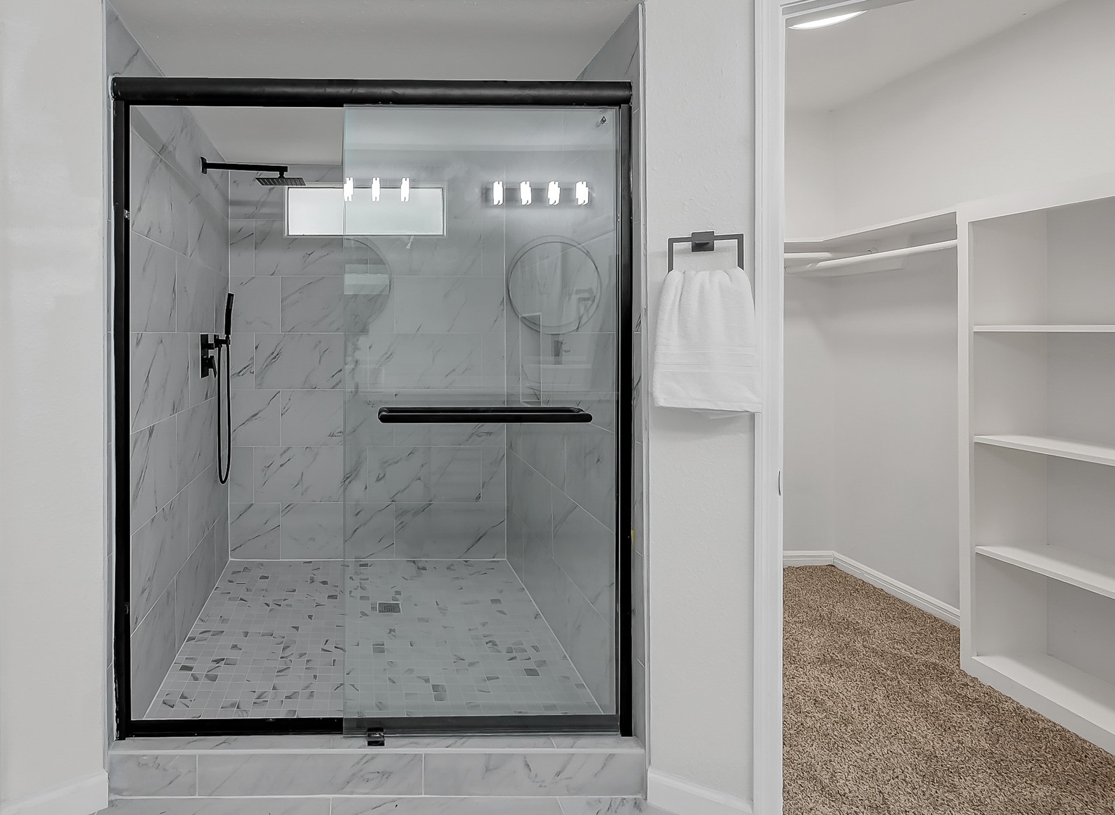 7610 Theisswood Road Spring, TX 77379 - Photo 24 of 42 a bathroom with a glass shower door