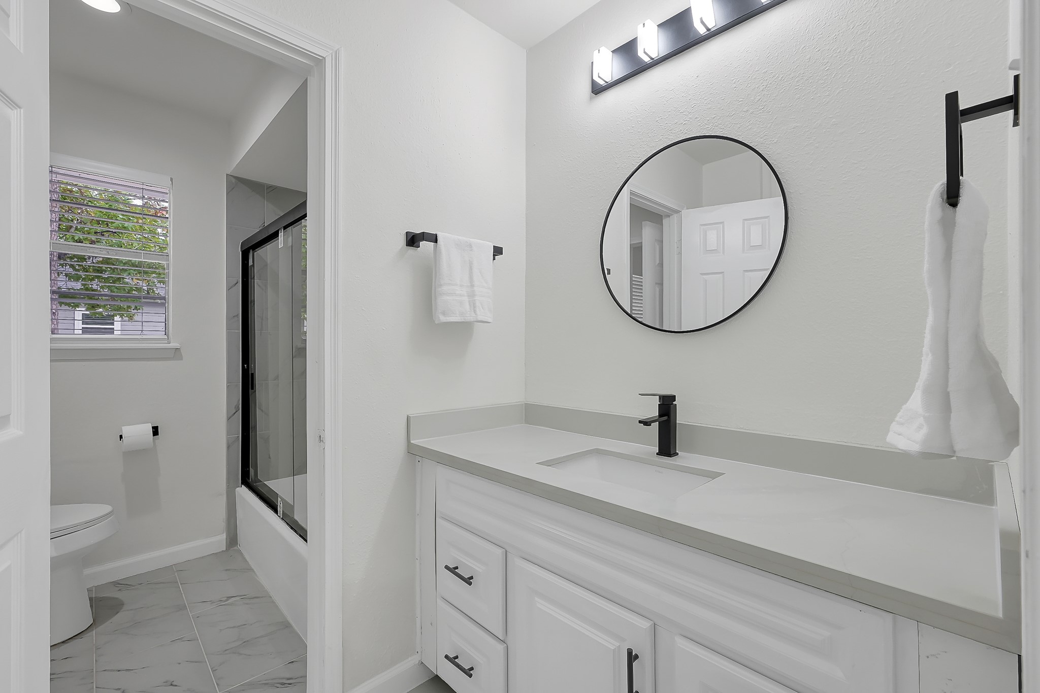 7610 Theisswood Road Spring, TX 77379 - Photo 30 of 42 a bathroom with a sink a toilet and a mirror