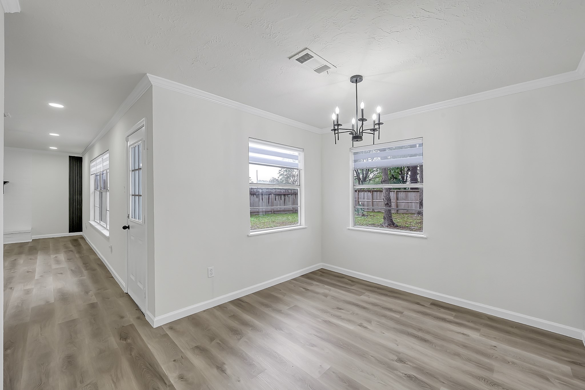7610 Theisswood Road Spring, TX 77379 - Photo 6 of 42 wooden floor in an empty room with a window