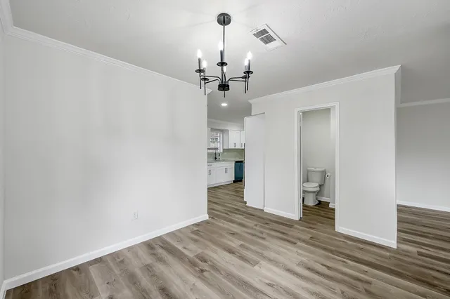 a view of a kitchen with a sink and a chandelier