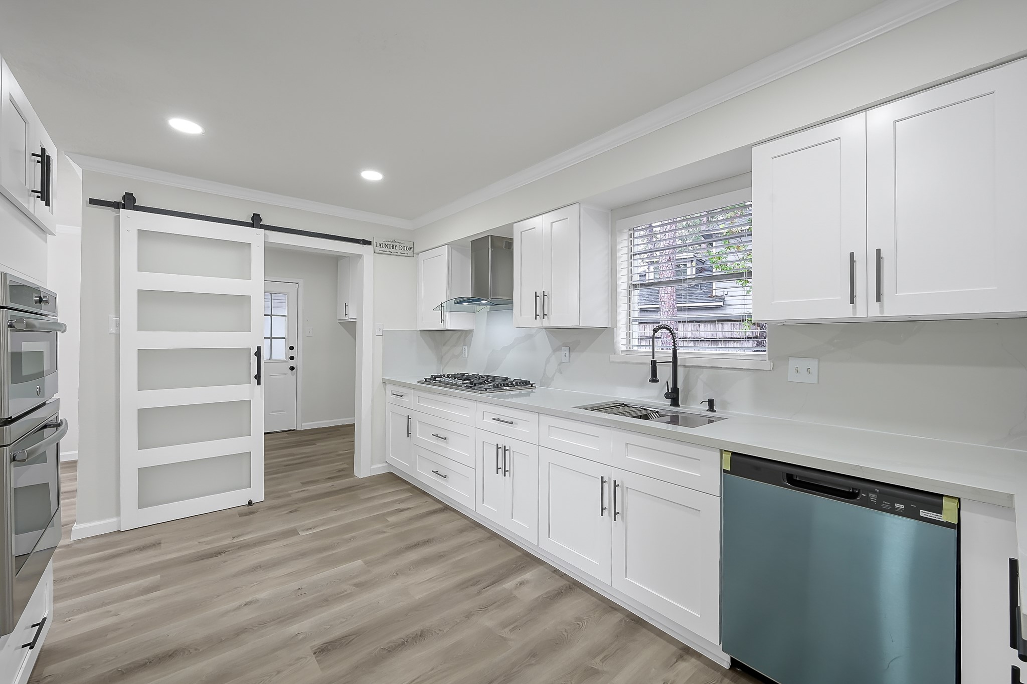 7610 Theisswood Road Spring, TX 77379 - Photo 9 of 42 a kitchen with stainless steel appliances granite countertop a sink stove and cabinets