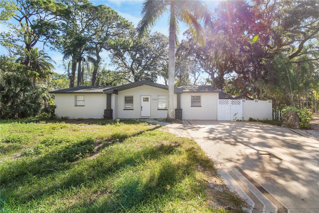 7040 Morningstar Lane New Port Richey, FL 34652 - Photo 1 of 1 a view of a house with a yard and tree