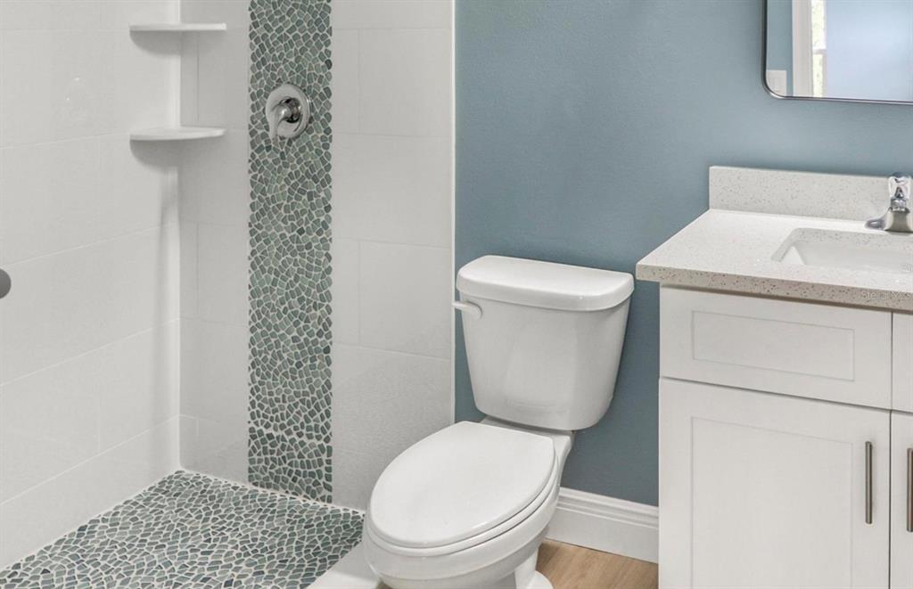 2005 Guava Drive Edgewater, FL 32141 - Photo 11 of 14 a white toilet sitting next to a shower curtain