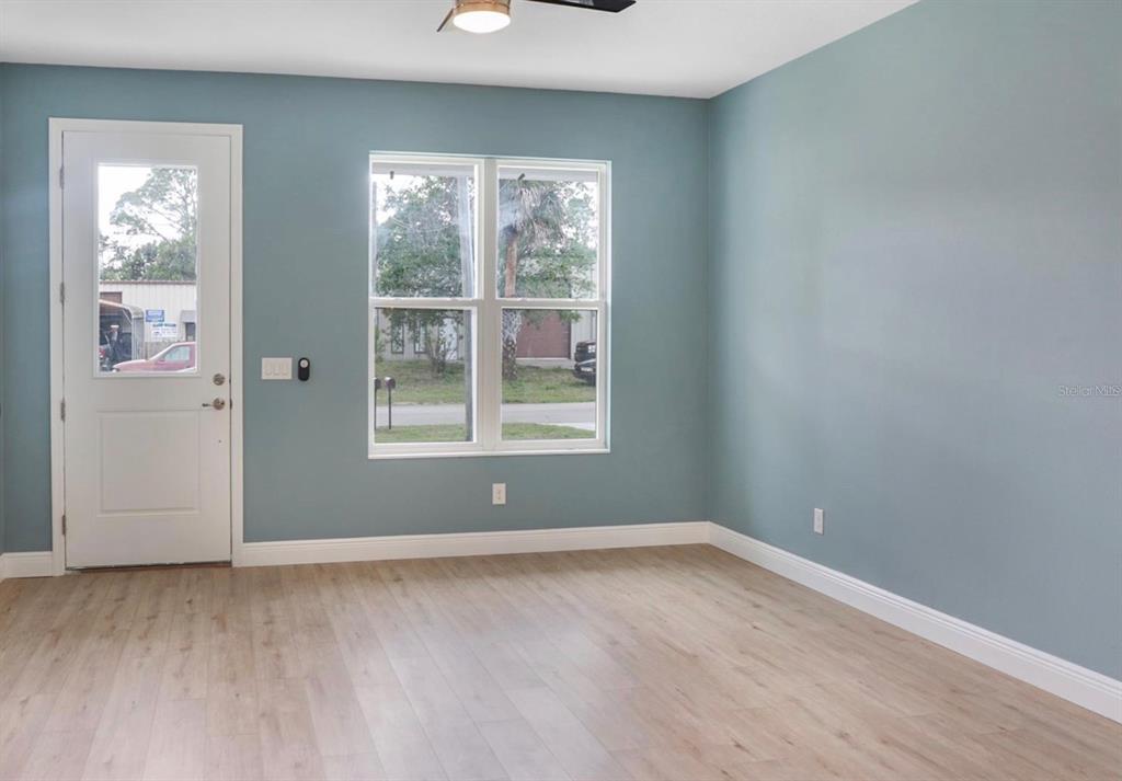 2005 Guava Drive Edgewater, FL 32141 - Photo 3 of 14 an empty room with wooden floor and windows