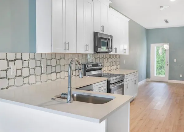 a kitchen with a sink and a microwave