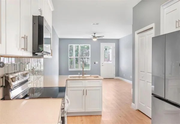a kitchen with a sink stove and refrigerator