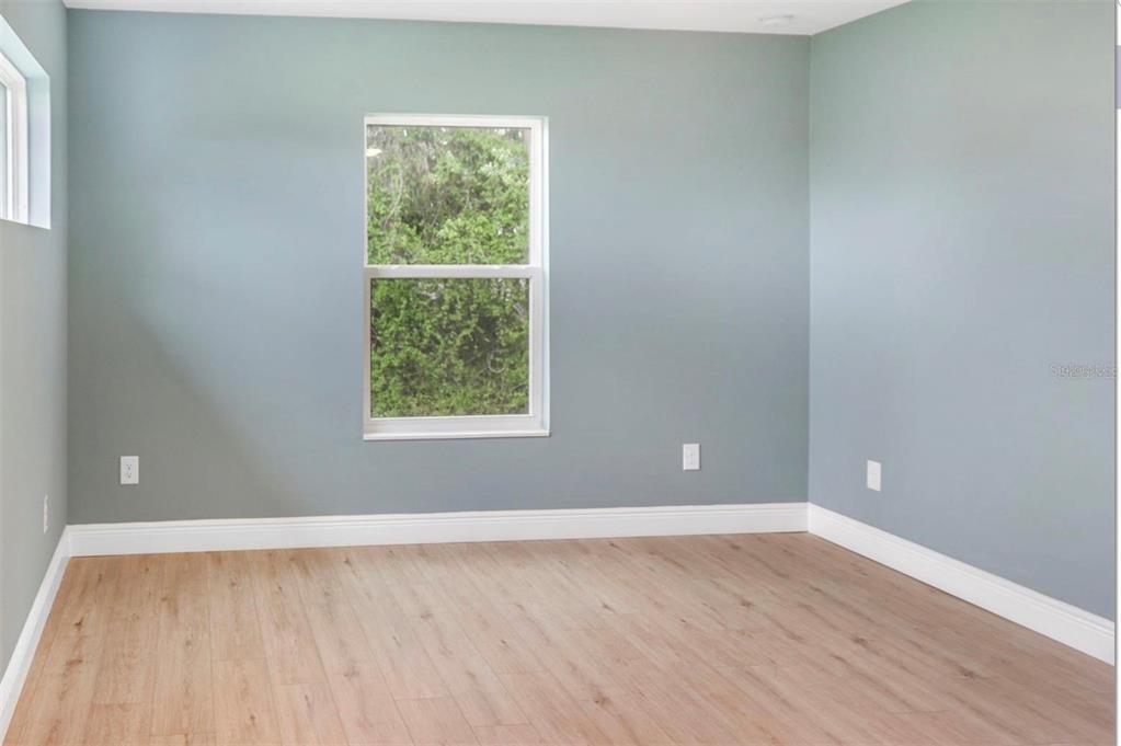 2005 Guava Drive Edgewater, FL 32141 - Photo 9 of 14 a view of an empty room with wooden floor and a window