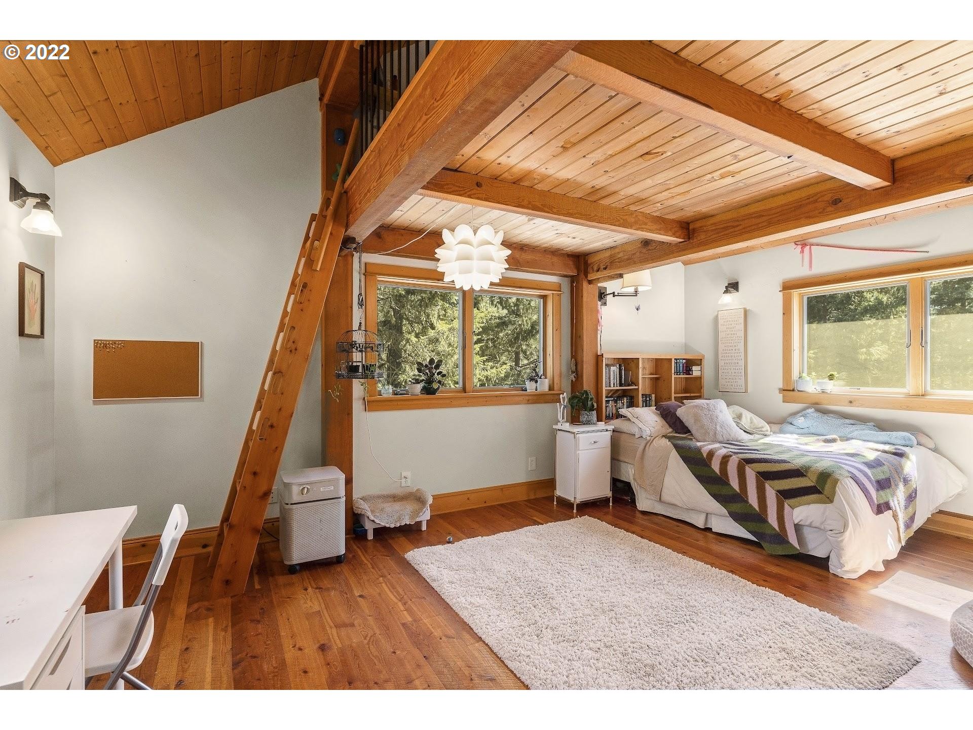 181 Lyons Road White Salmon, WA 98672 - Photo 16 of 32 a bedroom with furniture and a large window