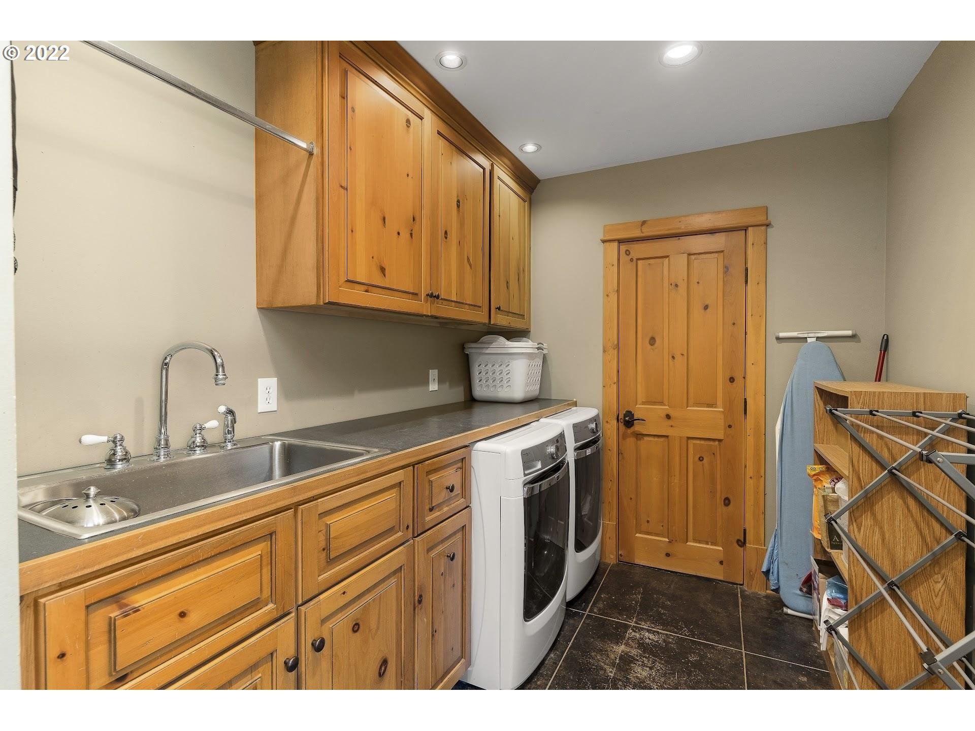 181 Lyons Road White Salmon, WA 98672 - Photo 20 of 32 a kitchen with stainless steel appliances granite countertop a sink a stove and a refrigerator with wooden cabinets