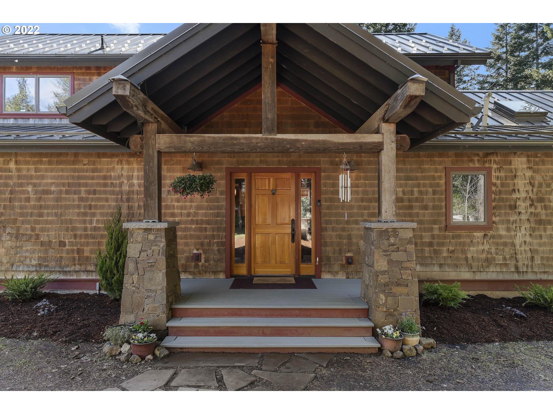 181 Lyons Road White Salmon, WA 98672 - Photo 3 of 32 a front view of a house with a garden