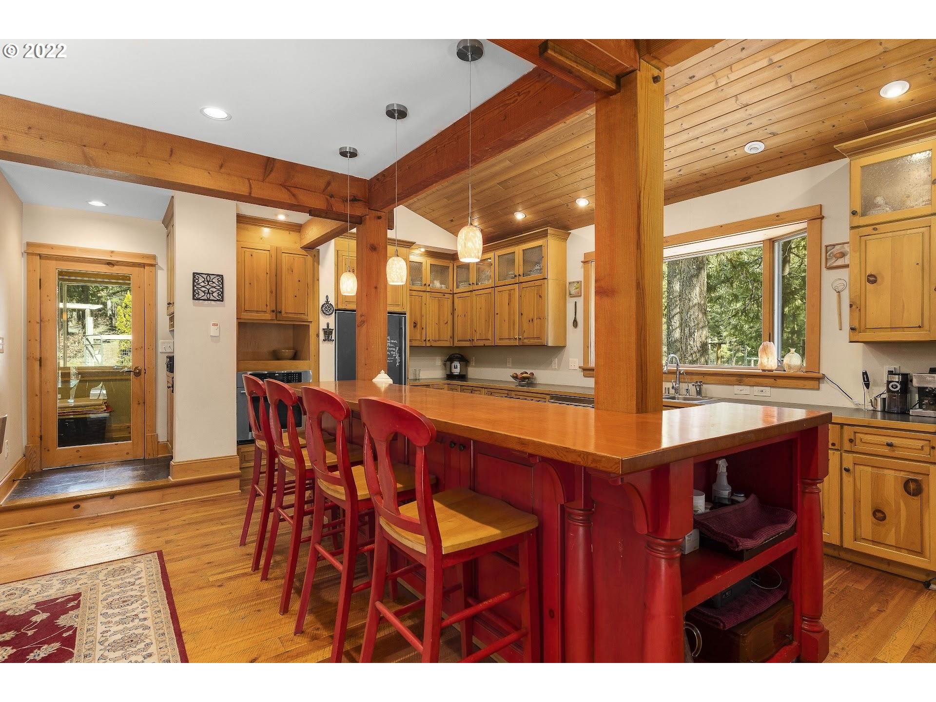 181 Lyons Road White Salmon, WA 98672 - Photo 9 of 32 a dining hall with stainless steel appliances kitchen island granite countertop a table and chairs