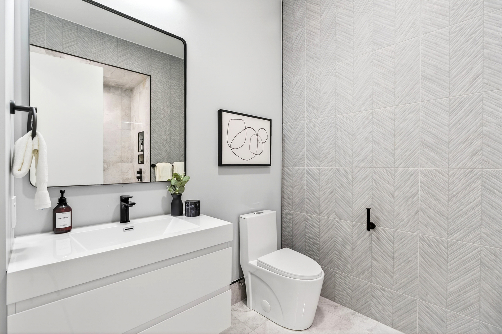 2024 West Irving Park Road, Unit 302 Chicago, IL 60618 - Photo 23 of 32 a bathroom with a toilet a sink a mirror and vanity