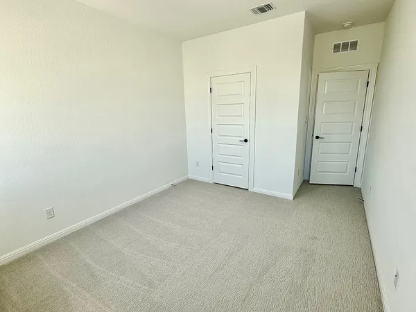 an empty room with closet area