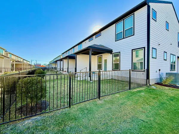a view of a house with a small yard and plants