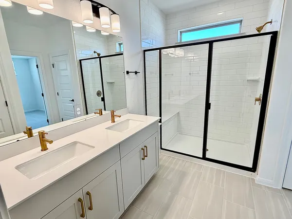 a bathroom with a double vanity sink and mirror