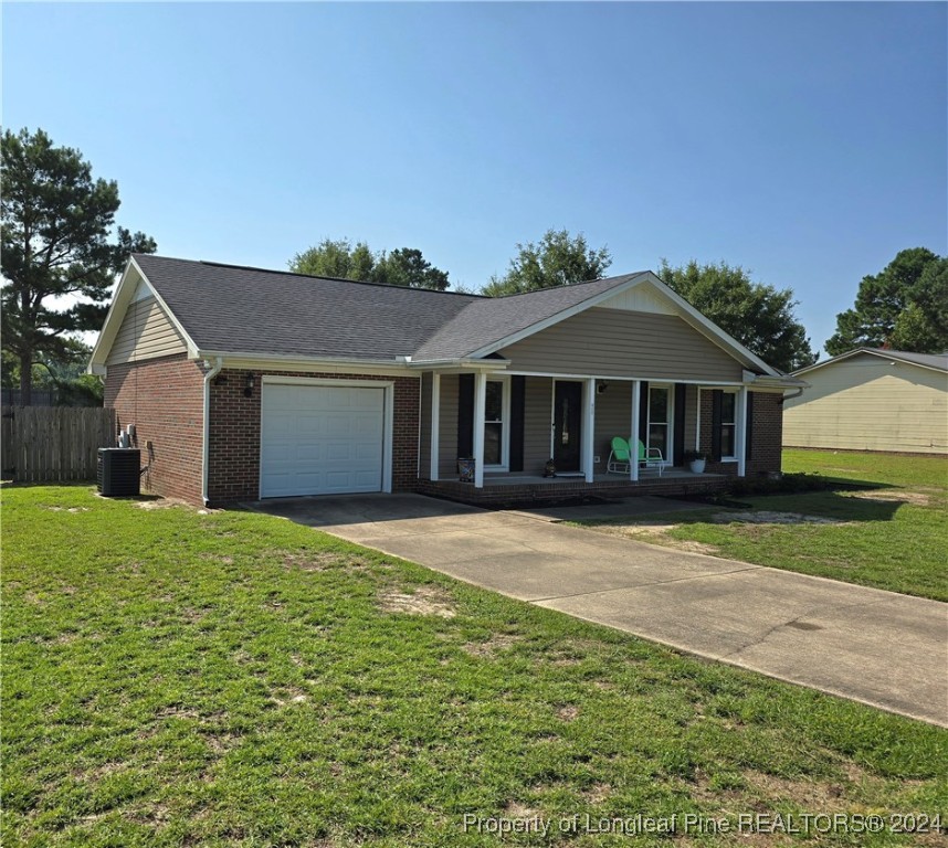 7605 Elliott Bridge Road Spring Lake, NC 28390 - Photo 2 of 36 a front view of a house with a garden