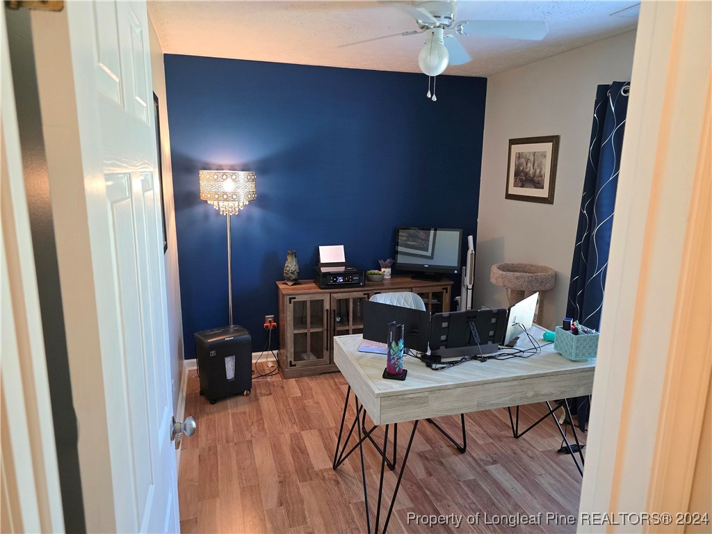 7605 Elliott Bridge Road Spring Lake, NC 28390 - Photo 26 of 36 a workspace with furniture and wooden floor
