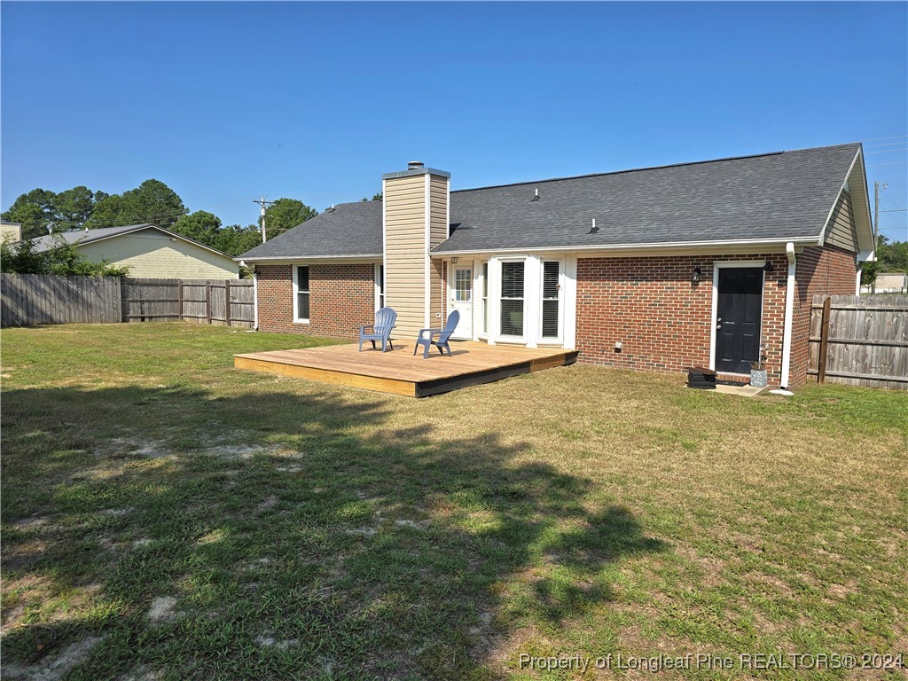 7605 Elliott Bridge Road Spring Lake, NC 28390 - Photo 36 of 36 a view of a house with a yard