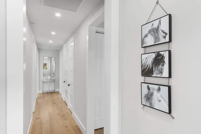 a view of hallway with wooden floor