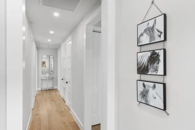 a view of hallway with wooden floor