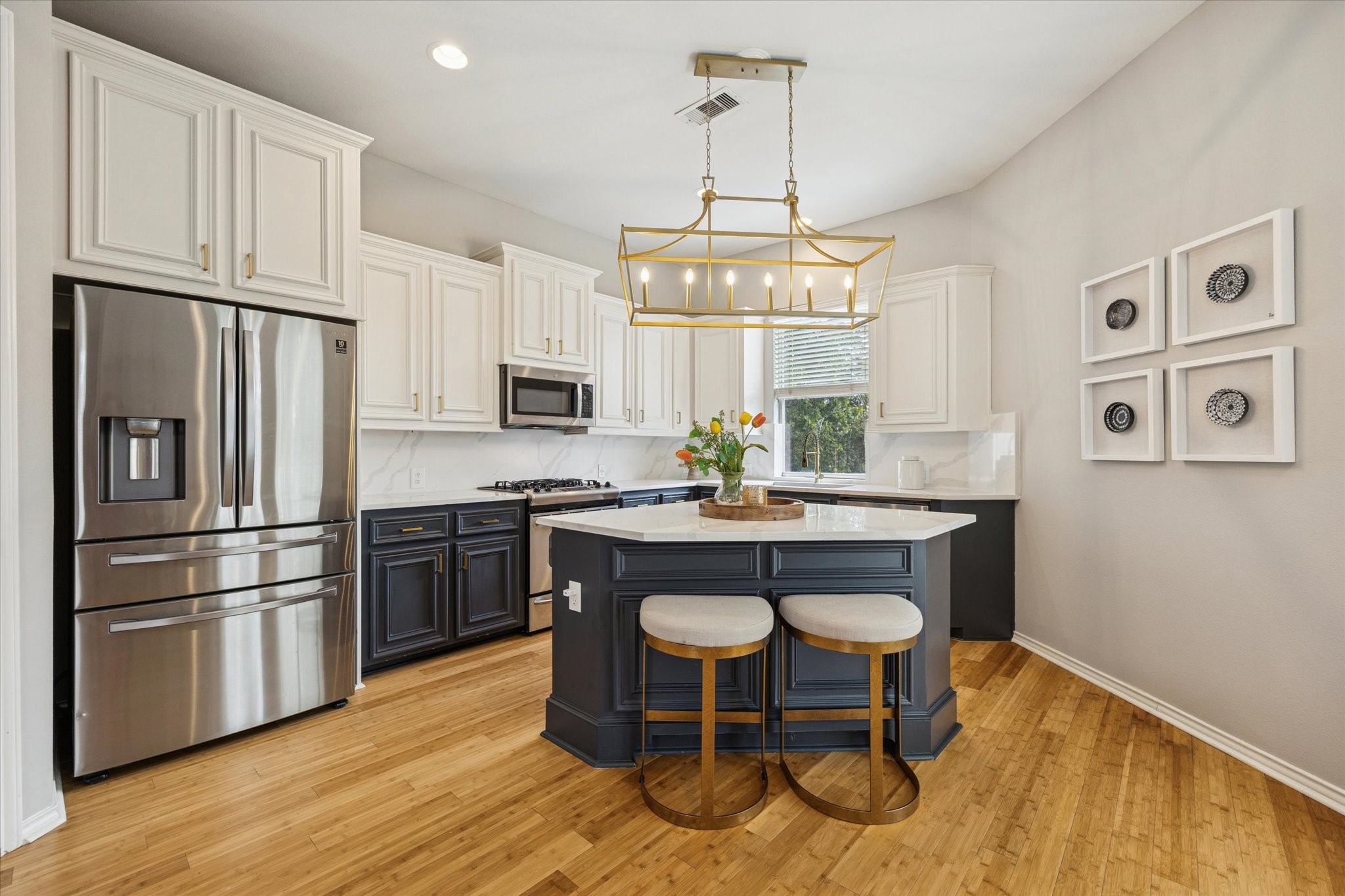 2607 Link Road Houston, TX 77009 - Photo 9 of 21 Island Kitchen with blue lower cabinets and white uppers, crisp white countertops and stainless-steel appliances