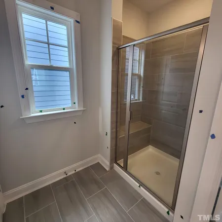 a bathroom with a shower and a window