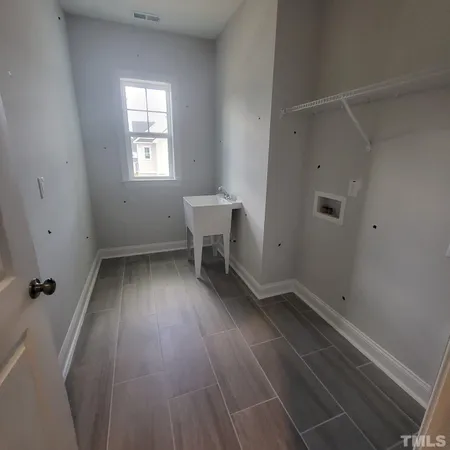 a view of a room with wooden floor and window