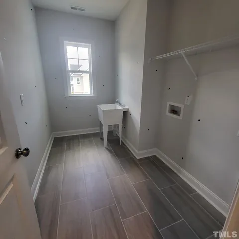 a view of a room with wooden floor and window