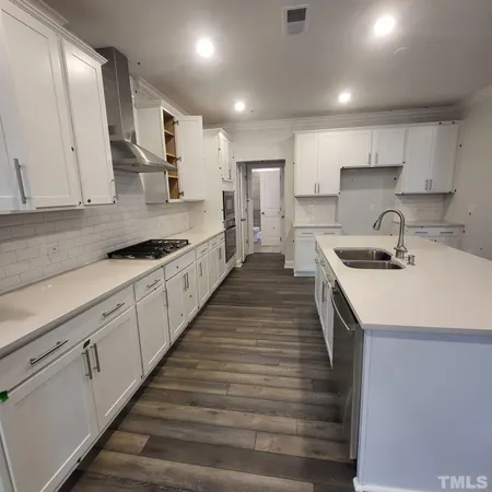 a kitchen with sink and cabinets