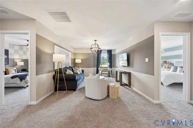 a living room with furniture and a chandelier