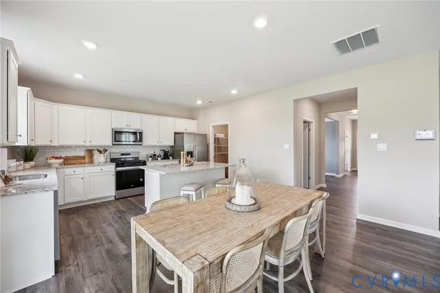 a kitchen with a table and chairs in it