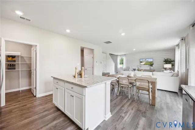 a kitchen with a sink cabinets and wooden floor